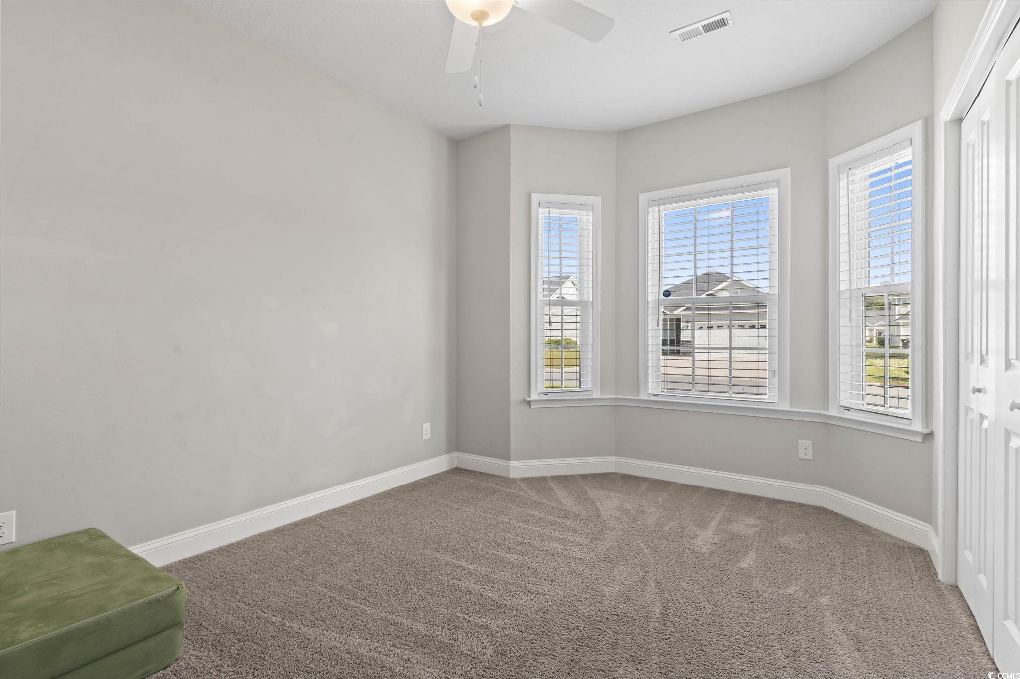712 Hobonny Loop Longs, SC 29568 - Photo 21 of 39 Empty room featuring ceiling fan, visible vents, baseboards, and carpet