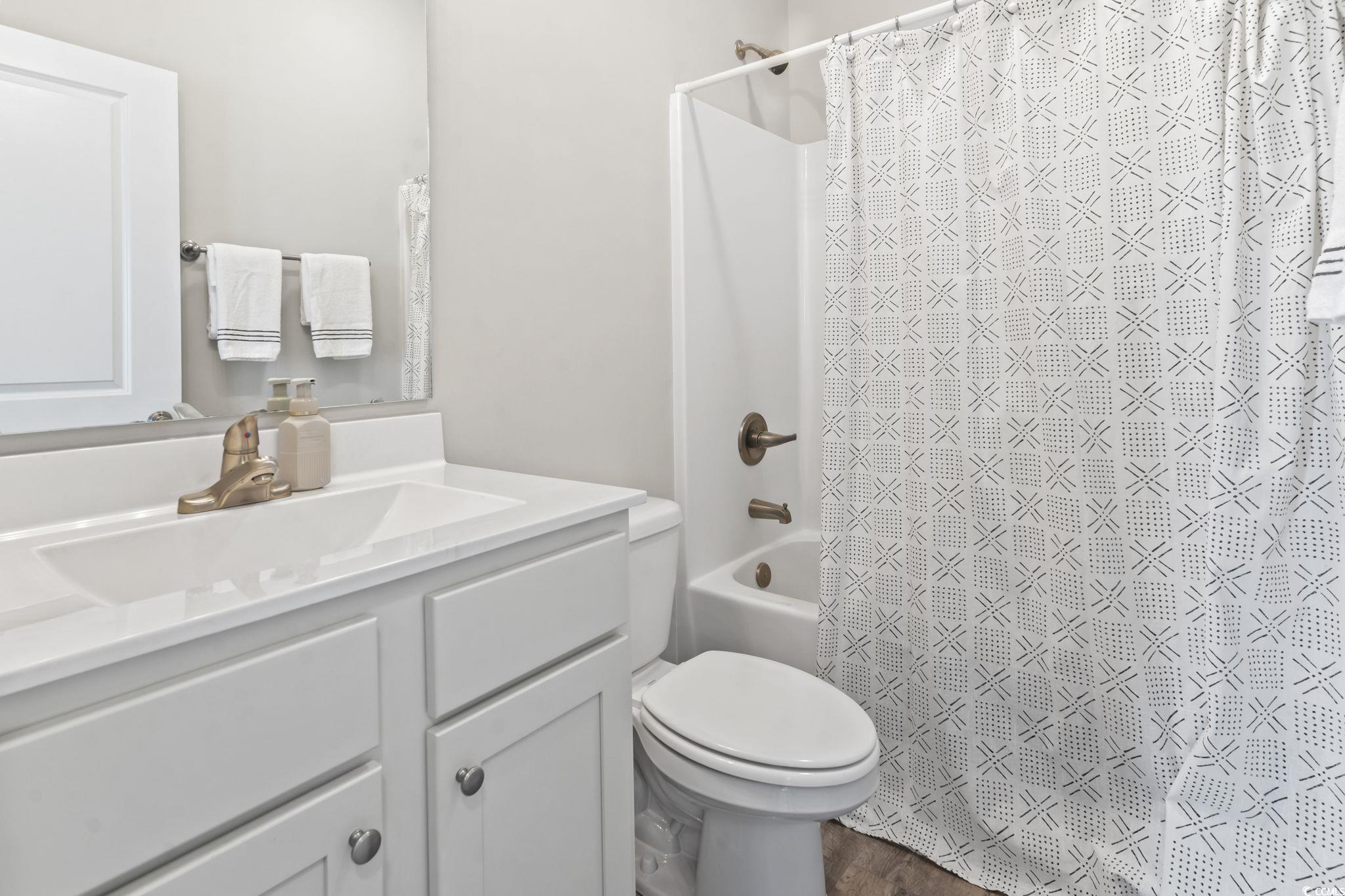712 Hobonny Loop Longs, SC 29568 - Photo 24 of 39 Bathroom with vanity, toilet, and shower / tub combo with curtain