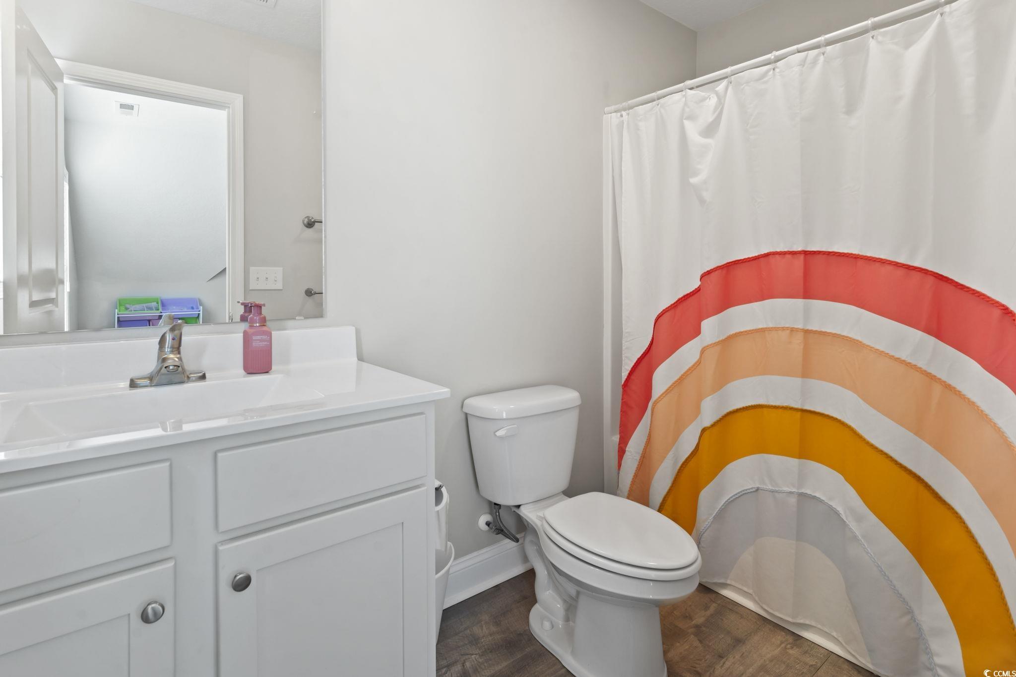 712 Hobonny Loop Longs, SC 29568 - Photo 28 of 39 Full bathroom with vanity, a shower with curtain, toilet, and wood finished floors