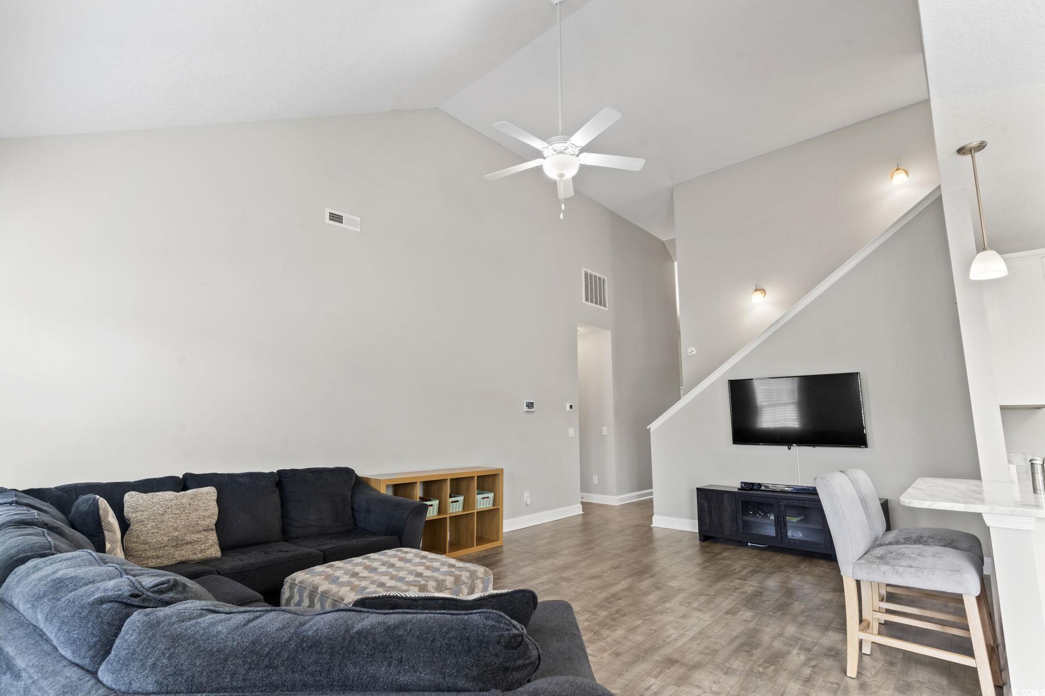 712 Hobonny Loop Longs, SC 29568 - Photo 7 of 39 Living area with a ceiling fan, high vaulted ceiling, visible vents, and wood finished floors