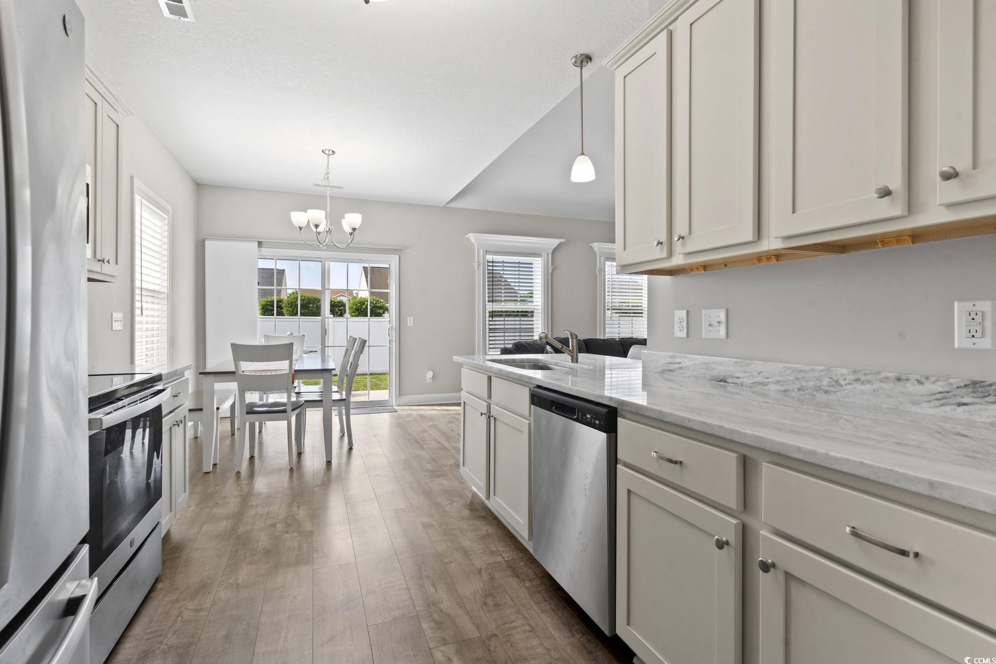 712 Hobonny Loop Longs, SC 29568 - Photo 10 of 39 Kitchen with pendant lighting, a sink, dark wood-style floors, a chandelier, and stainless steel appliances