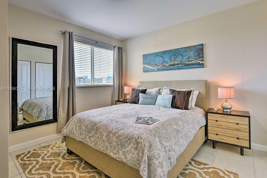 2280 Southwest 32nd Avenue, Unit 509 Miami, FL 33145 - Photo 12 of 22 a bedroom with bed and wooden floor