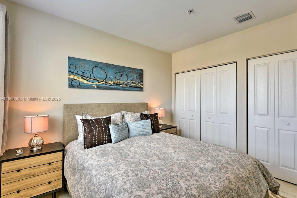 2280 Southwest 32nd Avenue, Unit 509 Miami, FL 33145 - Photo 13 of 26 a bedroom with a bed and wooden floor