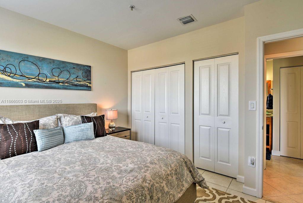 2280 Southwest 32nd Avenue, Unit 509 Miami, FL 33145 - Photo 15 of 26 a bedroom with a bed and wooden floor