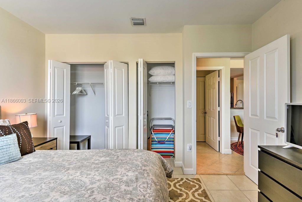 2280 Southwest 32nd Avenue, Unit 509 Miami, FL 33145 - Photo 16 of 22 a bedroom with a bed and a view of living room