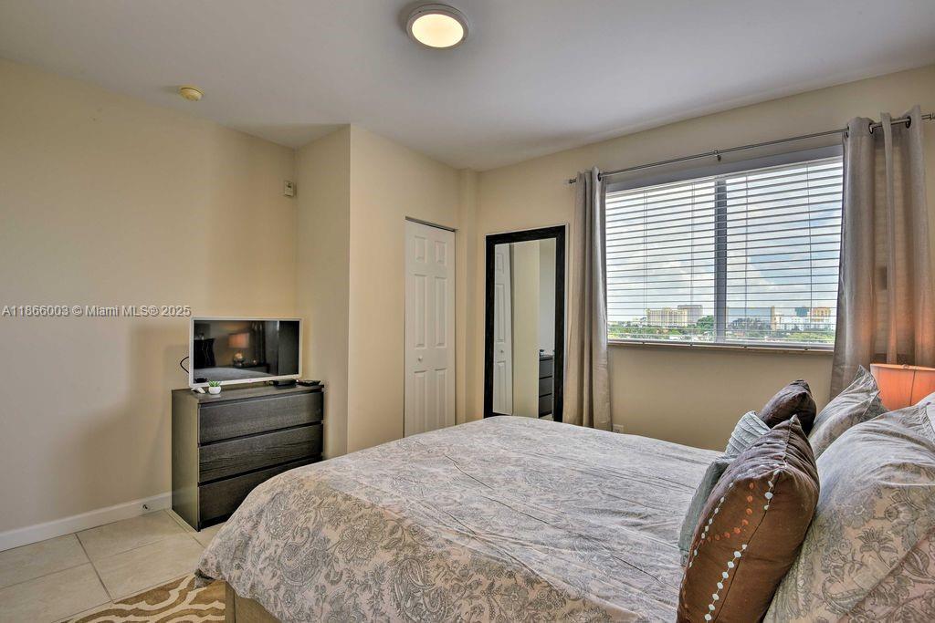 2280 Southwest 32nd Avenue, Unit 509 Miami, FL 33145 - Photo 17 of 26 a bedroom with a bed and a television