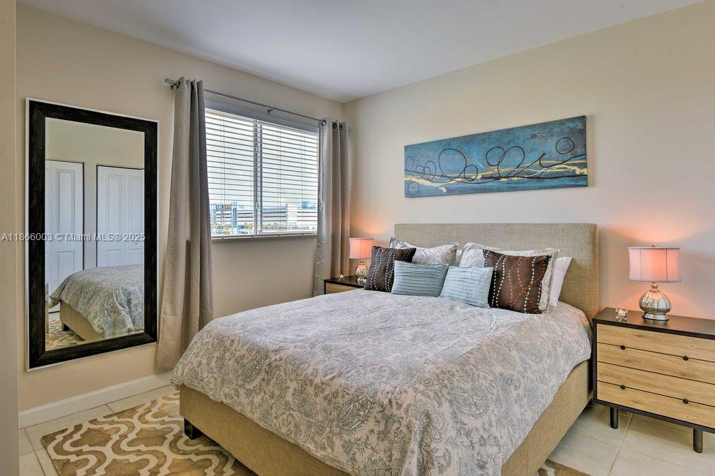 2280 Southwest 32nd Avenue, Unit 509 Miami, FL 33145 - Photo 18 of 26 a bedroom with a bed and a painting on the wall