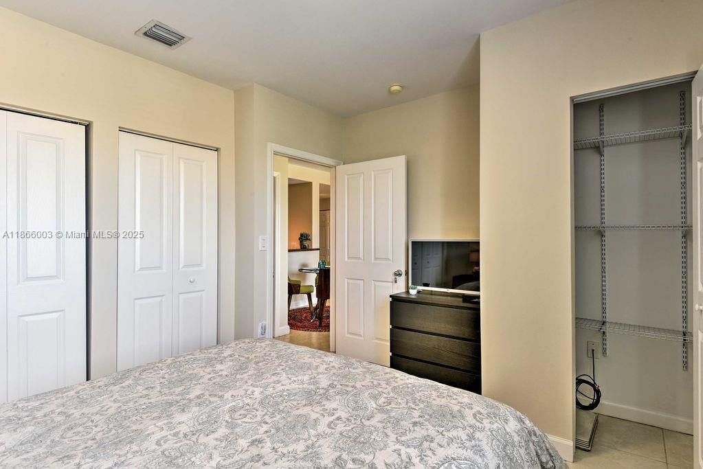 2280 Southwest 32nd Avenue, Unit 509 Miami, FL 33145 - Photo 19 of 26 a bedroom with a bed and a closet