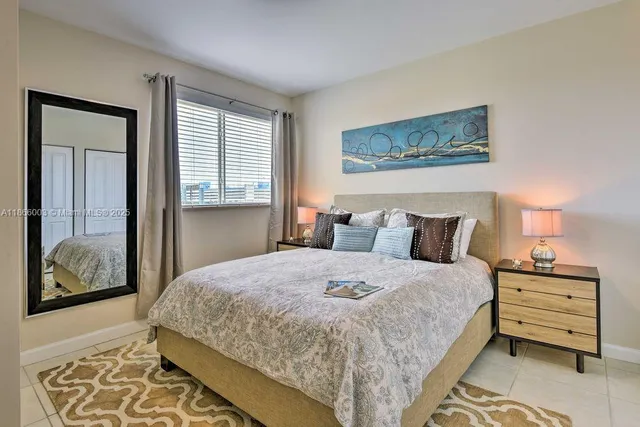 a bedroom with bed and wooden floor