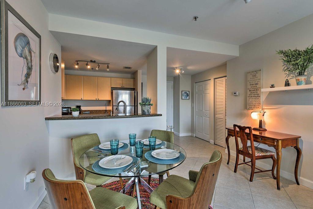 2280 Southwest 32nd Avenue, Unit 509 Miami, FL 33145 - Photo 6 of 22 a view of a dining room with furniture and a potted plant