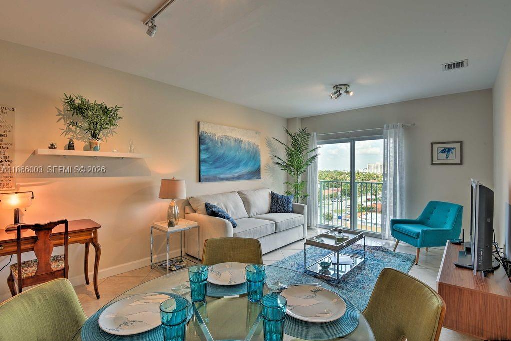 2280 Southwest 32nd Avenue, Unit 509 Miami, FL 33145 - Photo 7 of 22 a living room with furniture and a wooden floor