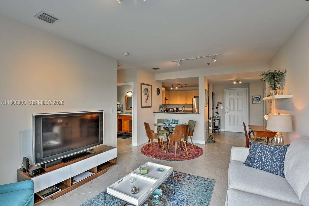 2280 Southwest 32nd Avenue, Unit 509 Miami, FL 33145 - Photo 9 of 22 a living room with furniture and a flat screen tv