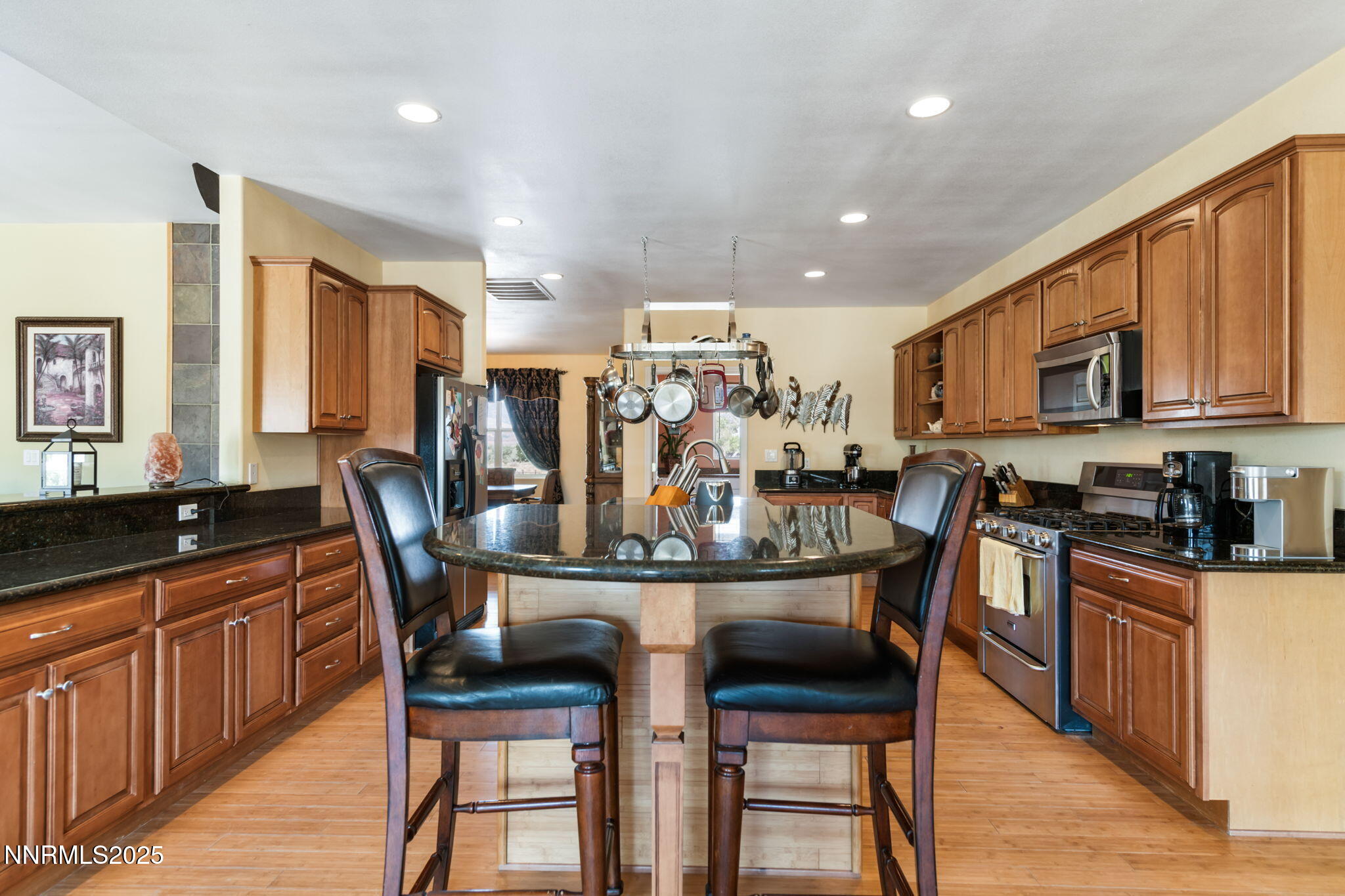 275 Imperial Road Dayton, NV 89403 - Photo 15 of 53 a kitchen with stainless steel appliances kitchen island granite countertop a dining table chairs and granite counter tops