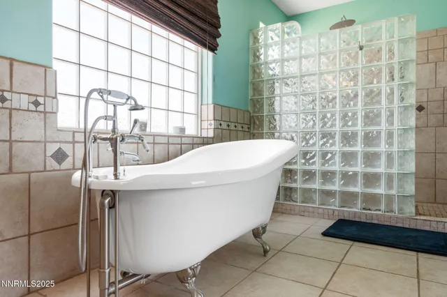 a bathroom with a granite countertop toilet sink and mirror