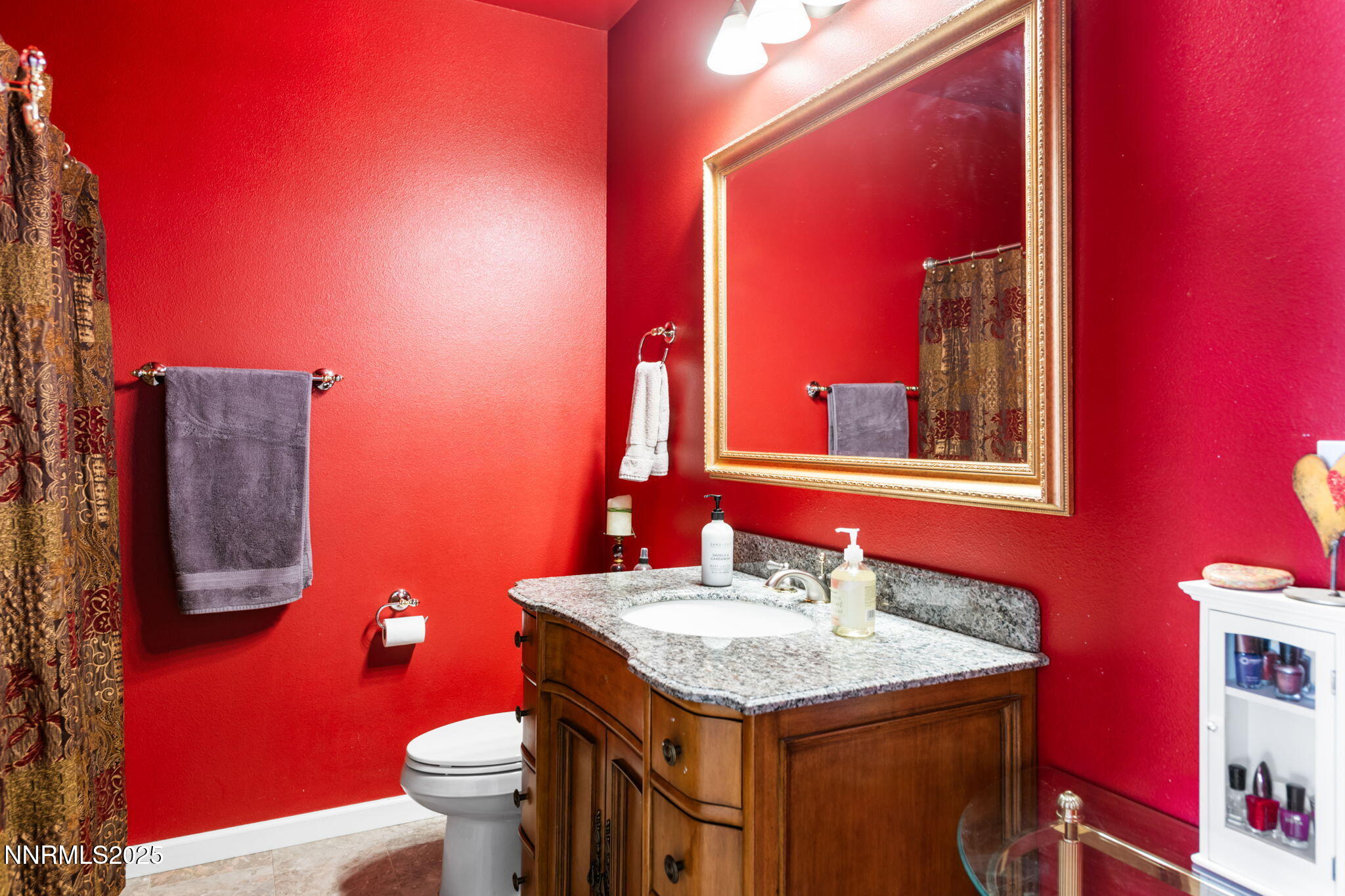 275 Imperial Road Dayton, NV 89403 - Photo 27 of 53 a bathroom with a granite countertop toilet sink and mirror