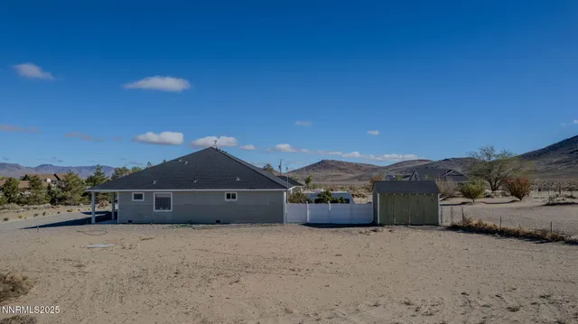 a view of a house with a yard and mountain view