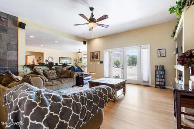 a living room with furniture and a view of kitchen