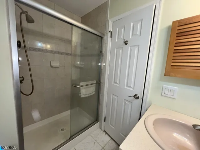 a bathroom with a granite countertop shower mirror and a sink