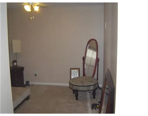 a view of a livingroom with furniture and a mirror