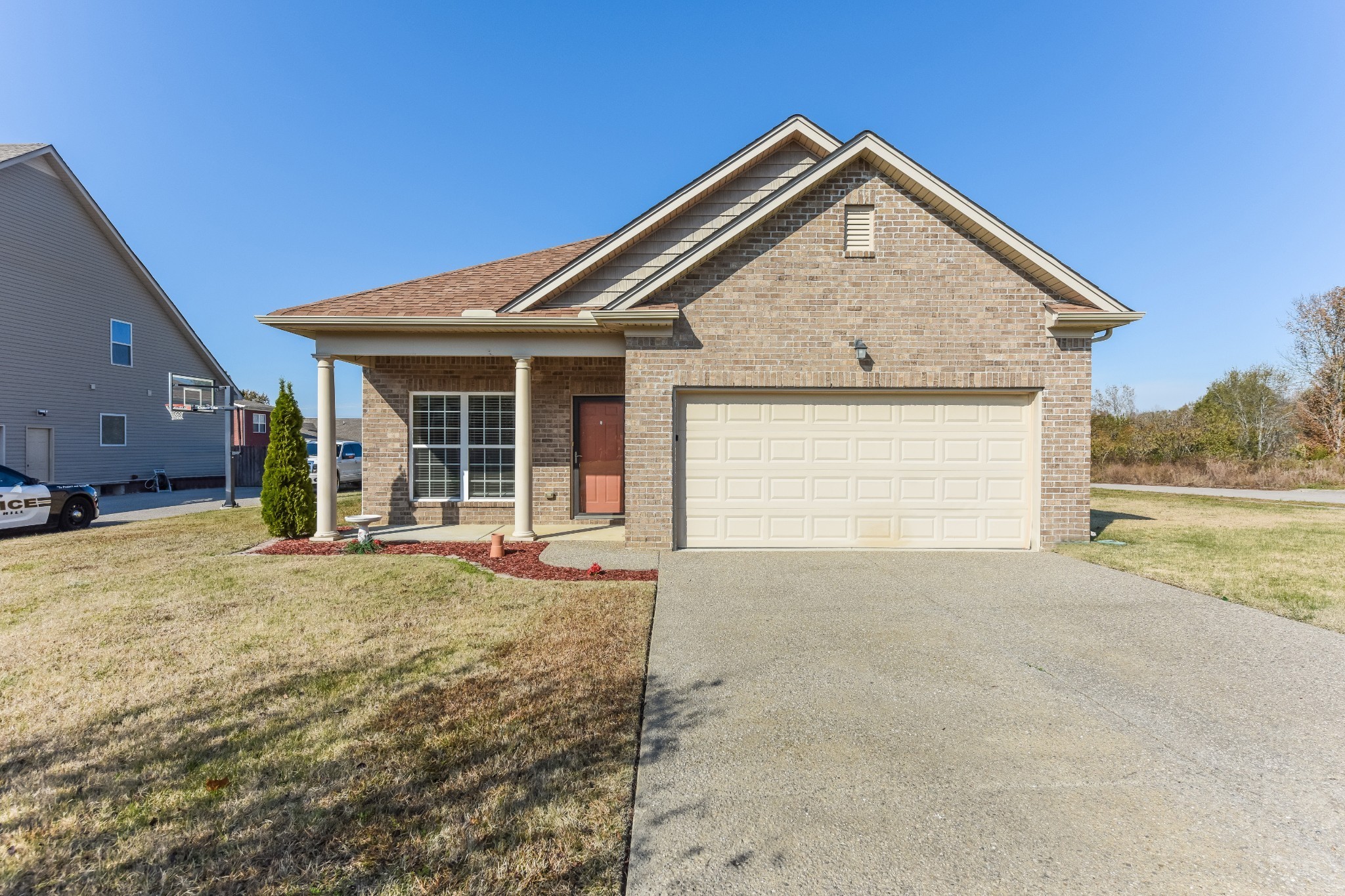 a view of a house with backyard and road