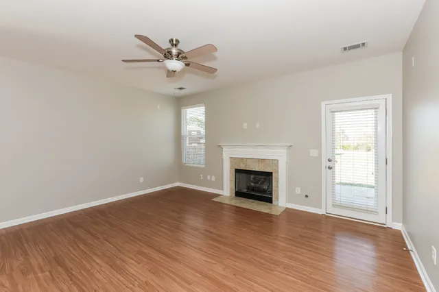 wooden floor in an empty room with a fireplace