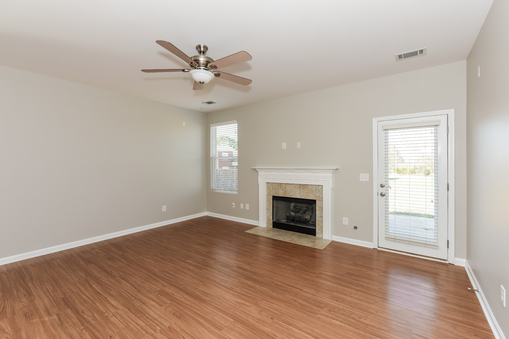 2015 Lincoln Road Spring Hill, TN 37174 - Photo 2 of 17 wooden floor in an empty room with a fireplace