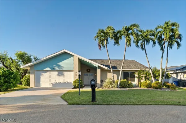 a view of a house with a yard and plants