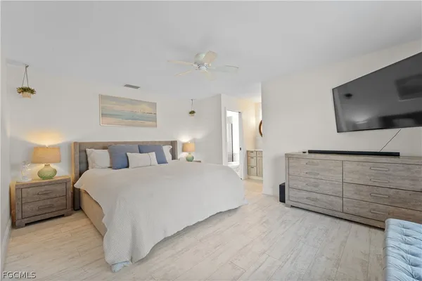 a bedroom with a bed and a flat screen tv