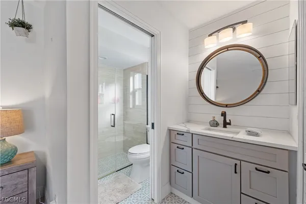 a bathroom with a toilet a sink and mirror