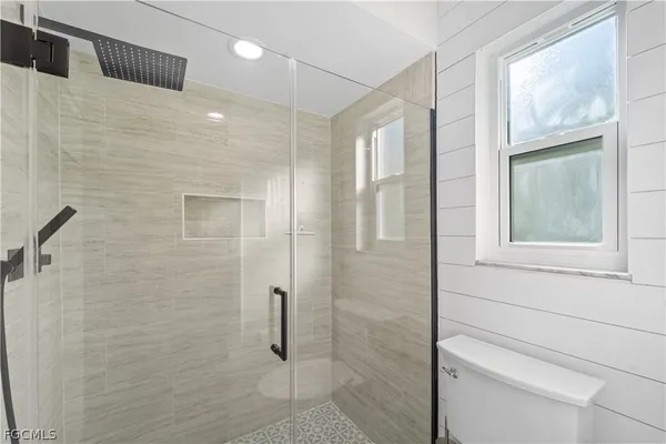 a bathroom with a shower and a toilet