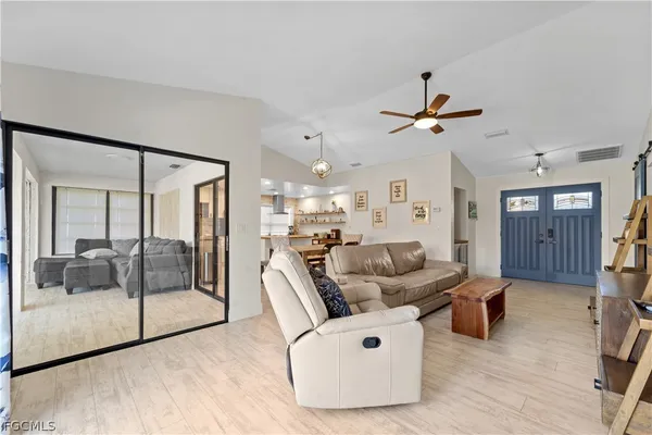 a living room with furniture and a large window