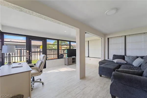 a living room with furniture and large windows