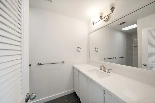 a bathroom with a sink and mirror