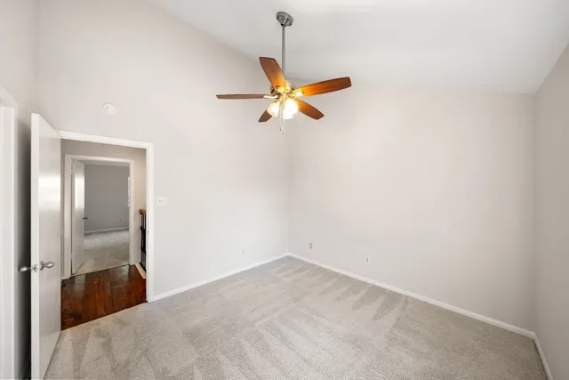 a view of a room with a ceiling fan and a window