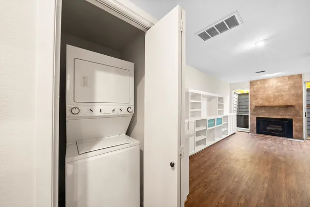 a view of a hallway with wooden floor and a fireplace