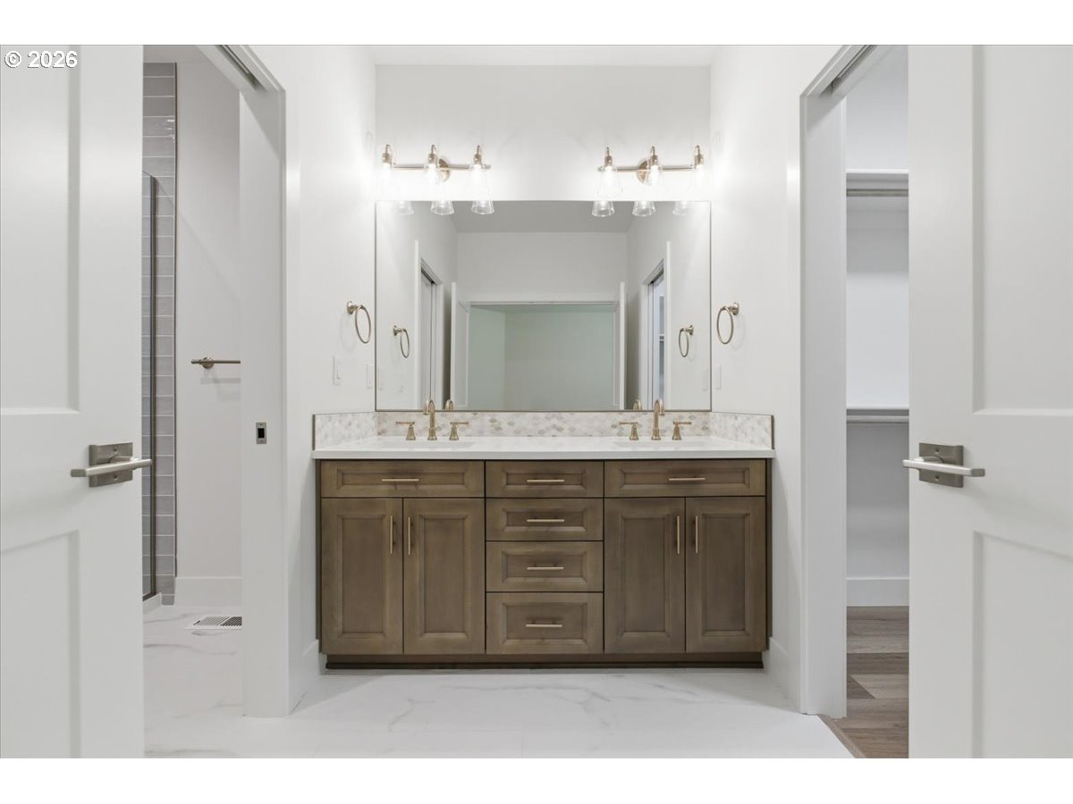 2147 Northeast Spitz Road Canby, OR 97013 - Photo 25 of 48 a bathroom with a double vanity sink and a mirror