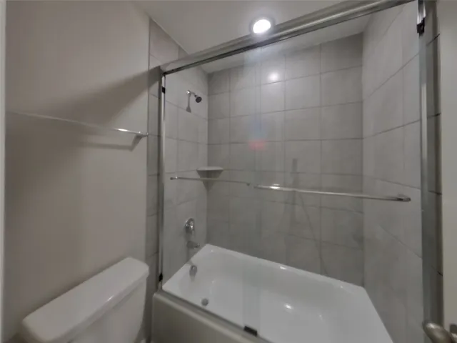 a bathroom with a bathtub and toilet