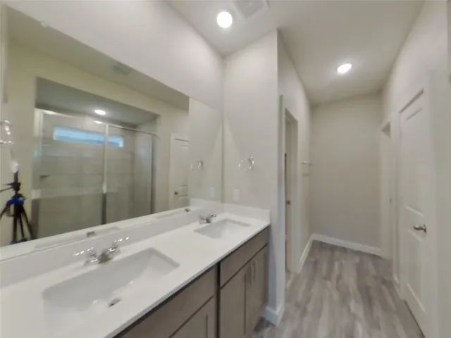 a bathroom with a sink mirror and a shower