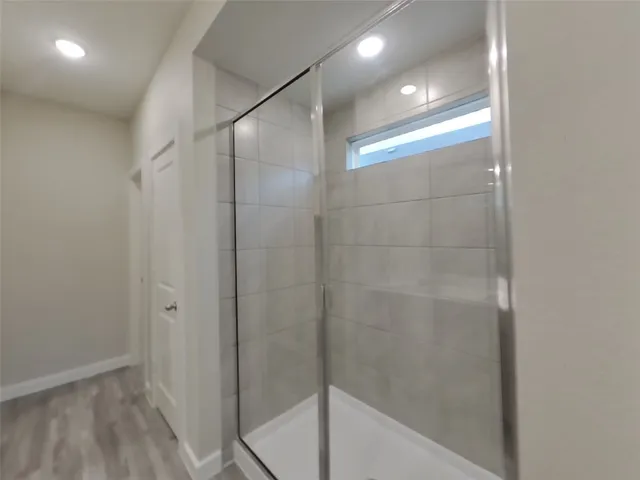 a bathroom with a glass shower door