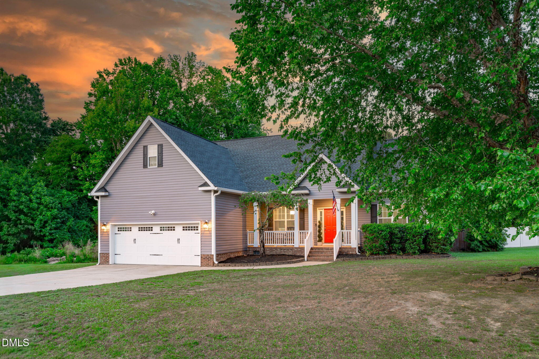 2450 Rolling Tracks Road Willow Spring, NC 27592 - Photo 58 of 64 a front view of a house with a yard and garage