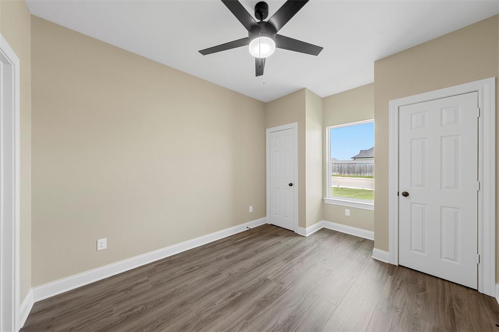 929 Northern Dancer Drive Hewitt, TX 76643 - Photo 26 of 36 an empty room with wooden floor and a ceiling fan