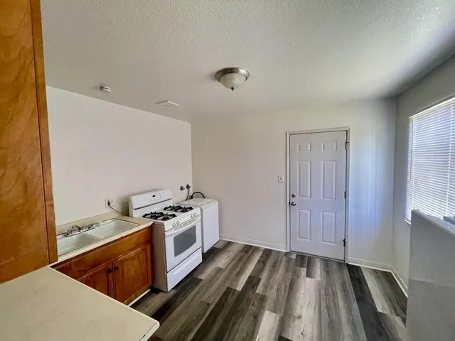 a kitchen with a stove and a refrigerator