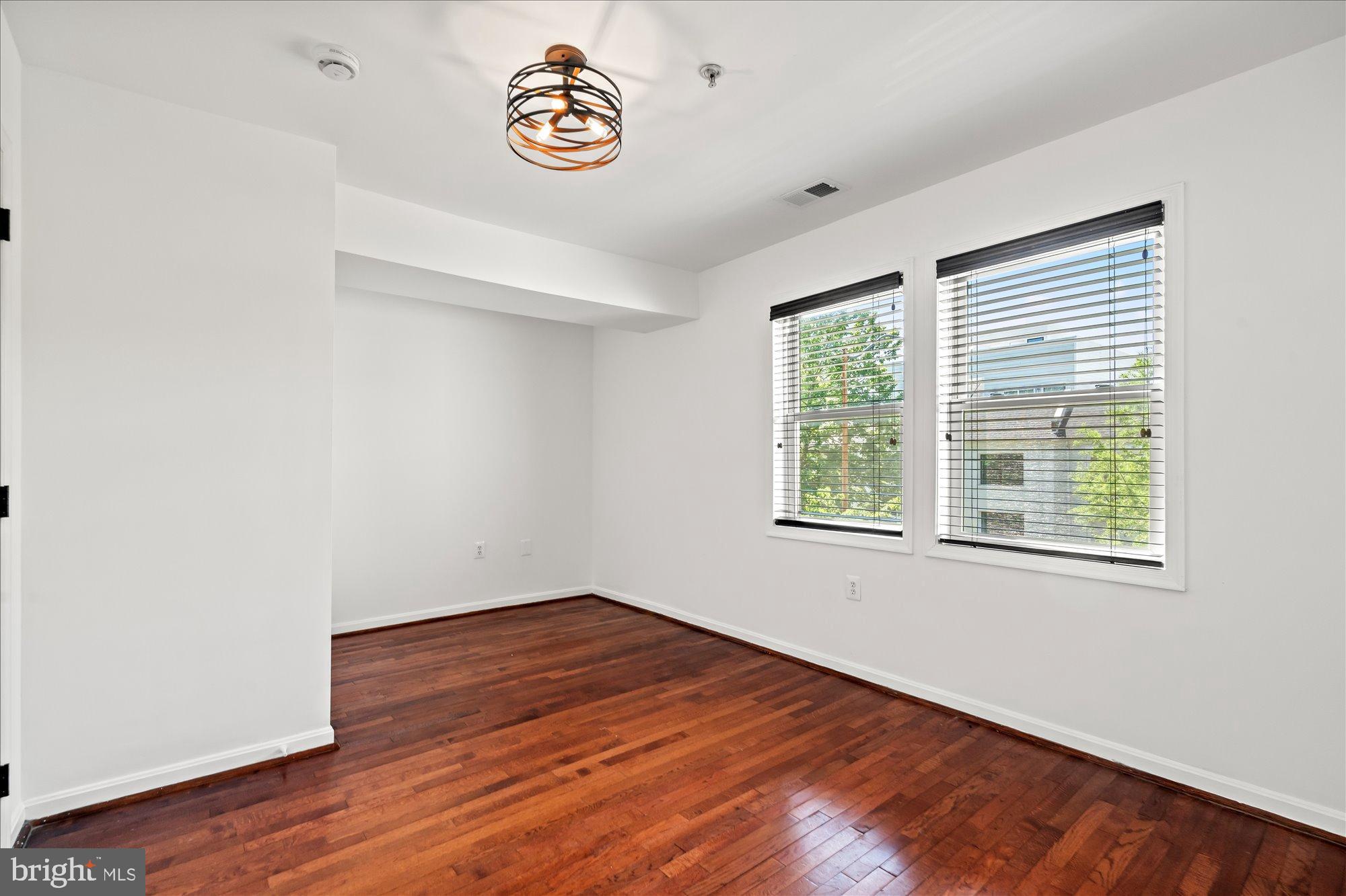 1241 18th Street Northeast, Unit 5 Washington, DC 20002 - Photo 11 of 17 an empty room with a window and wooden floor