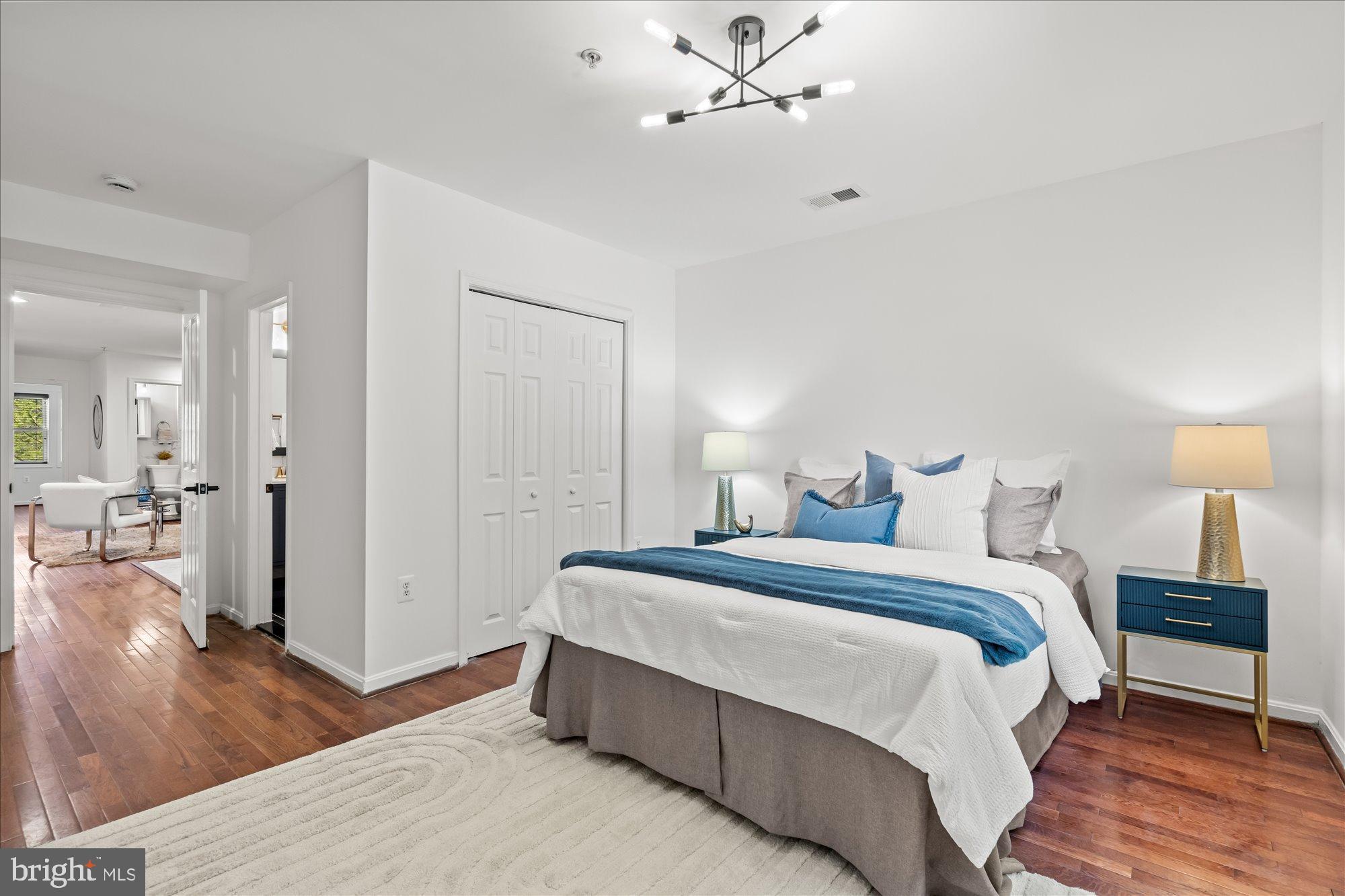 1241 18th Street Northeast, Unit 5 Washington, DC 20002 - Photo 10 of 17 a spacious bedroom with a bed and a chandelier