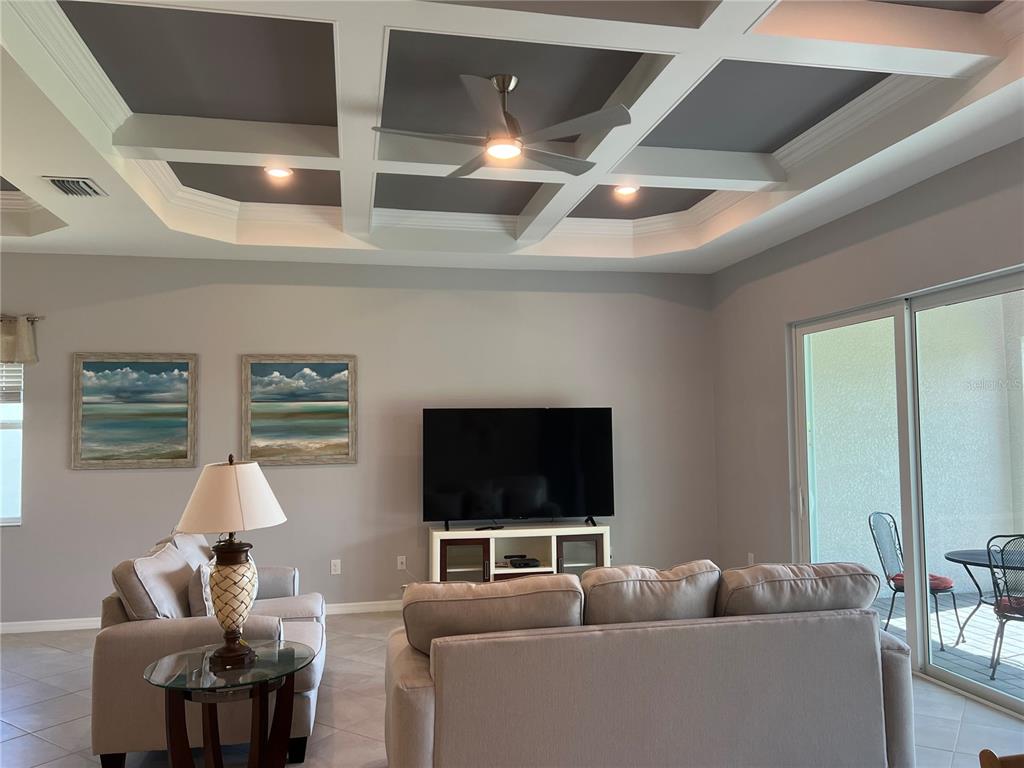 17535 Jadestone Court Venice, FL 34293 - Photo 16 of 92 a living room with furniture and a flat screen tv