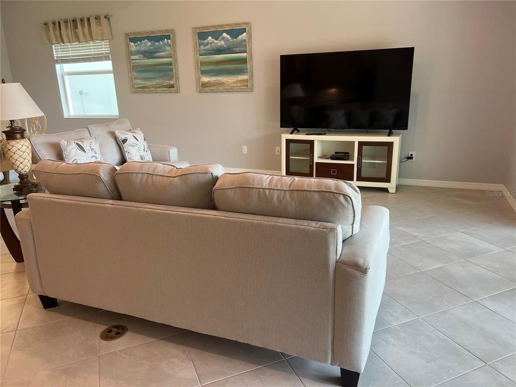 17535 Jadestone Court Venice, FL 34293 - Photo 17 of 92 a living room with furniture and a flat screen tv