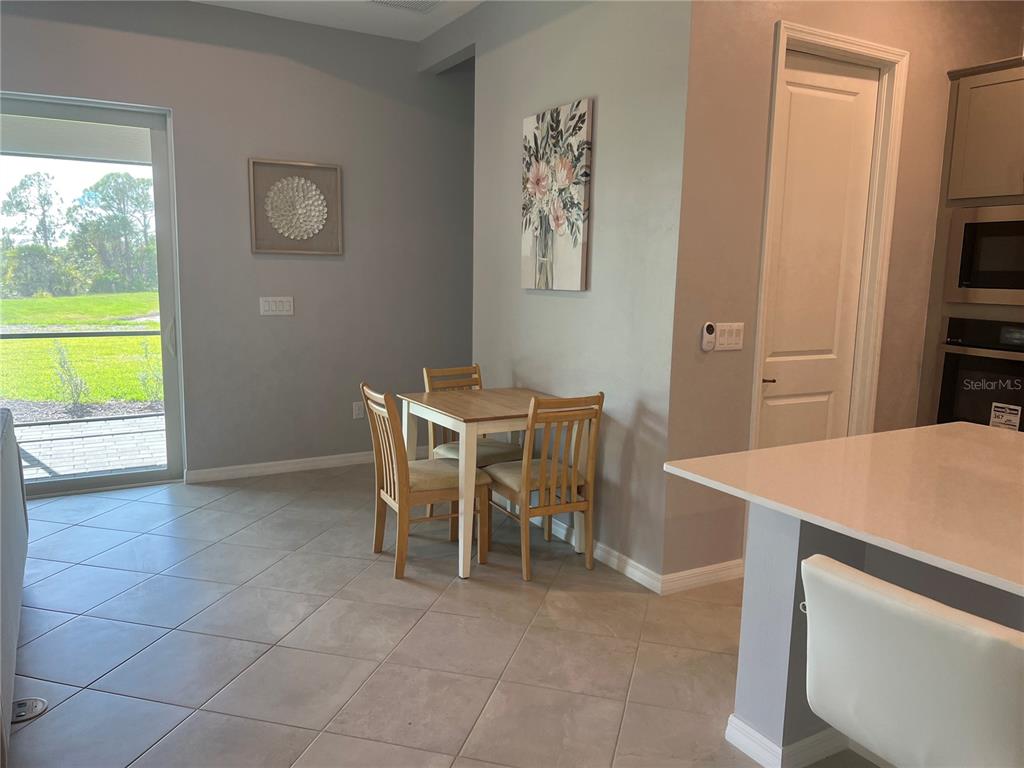 17535 Jadestone Court Venice, FL 34293 - Photo 21 of 92 a dining room with a table and chairs