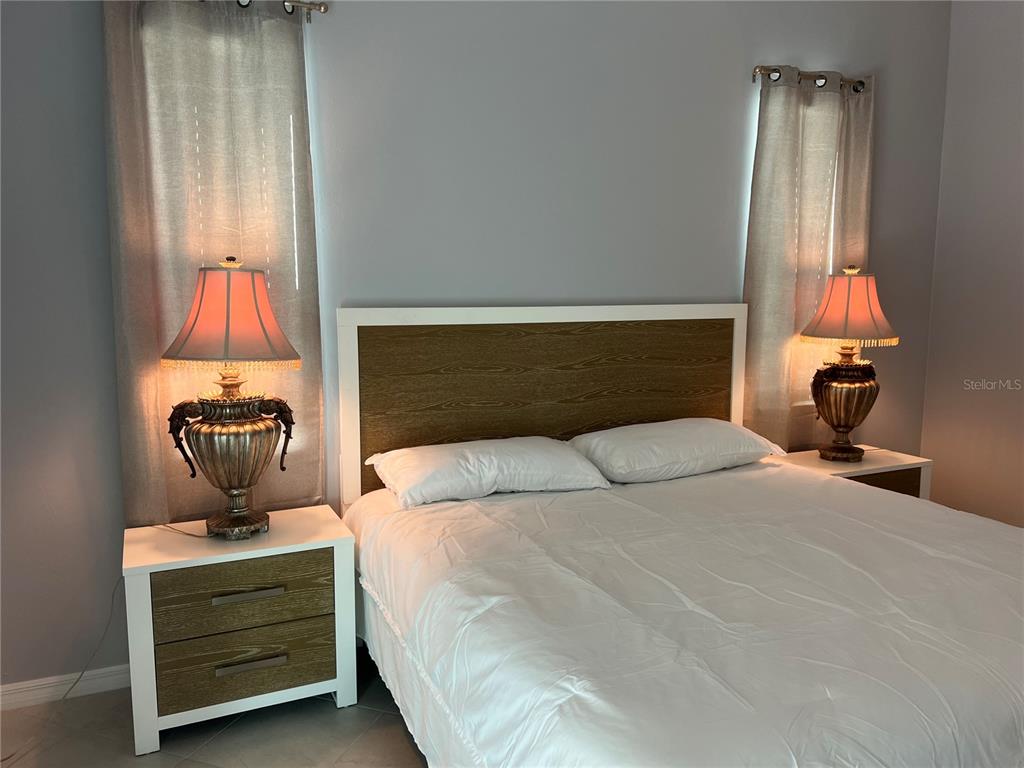 17535 Jadestone Court Venice, FL 34293 - Photo 26 of 92 a bedroom with a bed and wooden floor