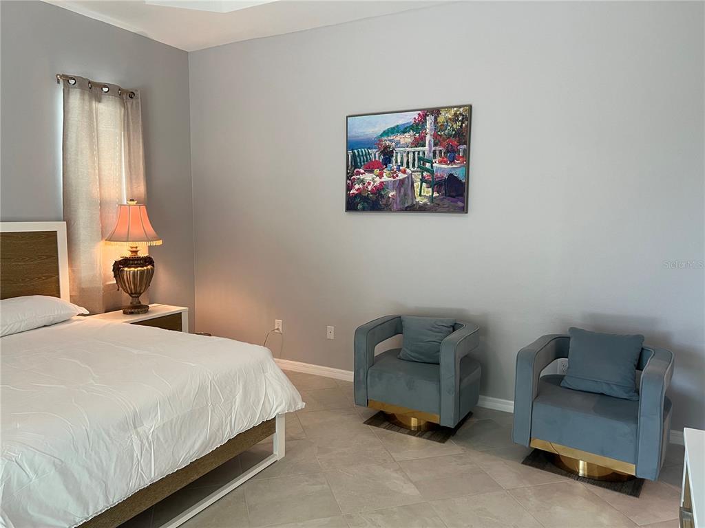 17535 Jadestone Court Venice, FL 34293 - Photo 27 of 92 a bedroom with a bed and a couch