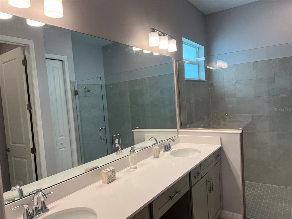 17535 Jadestone Court Venice, FL 34293 - Photo 32 of 92 a bathroom with a sink double vanity and a mirror